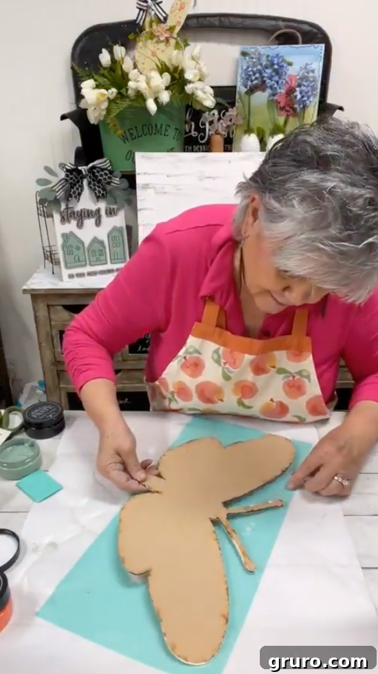 Applying butterfly stencil to wood cutout
