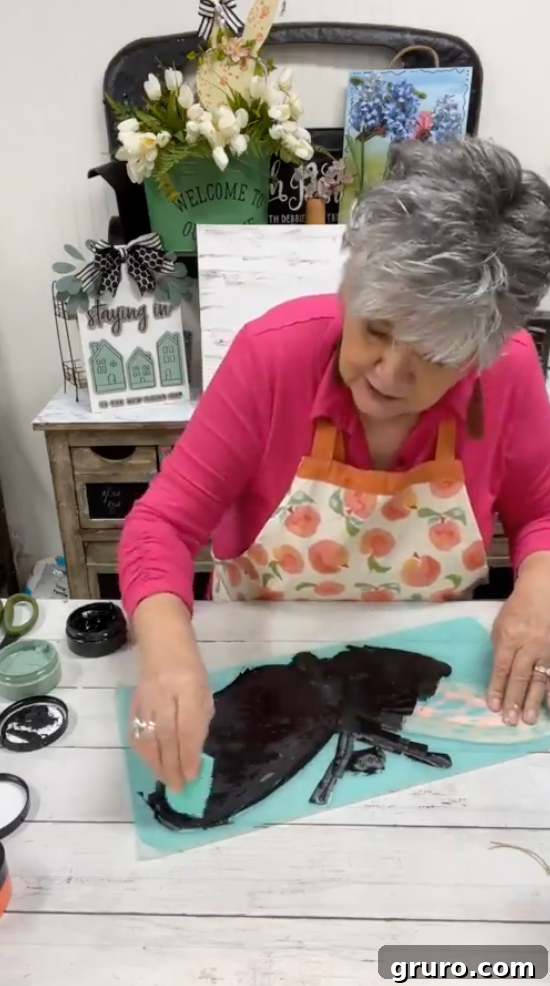 Using a squeegee to spread chalk paste evenly