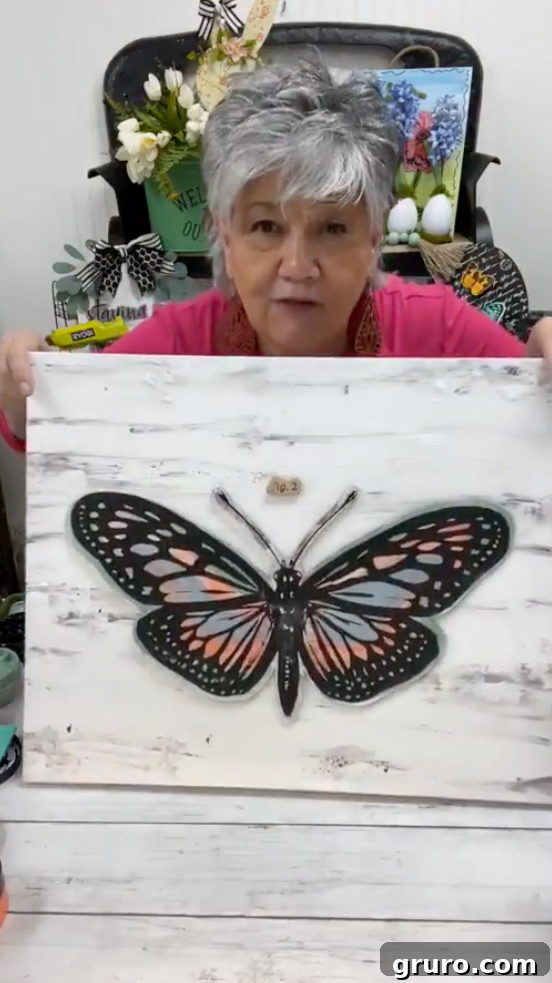 The finished butterfly art piece, glued to the canvas