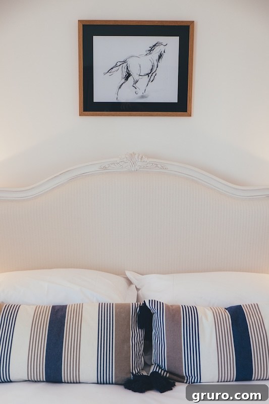 Bright modern farmhouse bedroom with white walls, vintage metal bed, and rustic decor