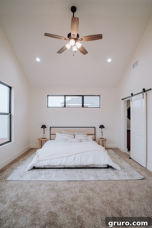 Modern farmhouse bedroom with white walls, green accents, and wooden furniture