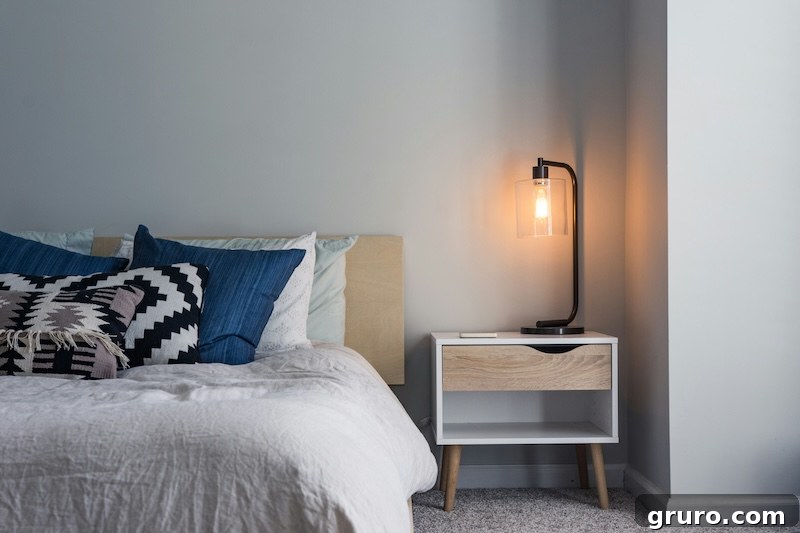 Inviting modern farmhouse bedroom featuring a bed with a rustic headboard and neutral colors
