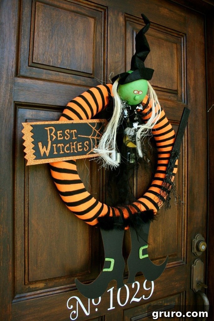A festive Halloween wreath with a witch theme, showcasing repurposed tights as part of its unique design, perfect for a welcoming front door