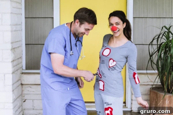 A couple dressed as the game board and patient from the classic 'Operation' board game, a humorous DIY costume.