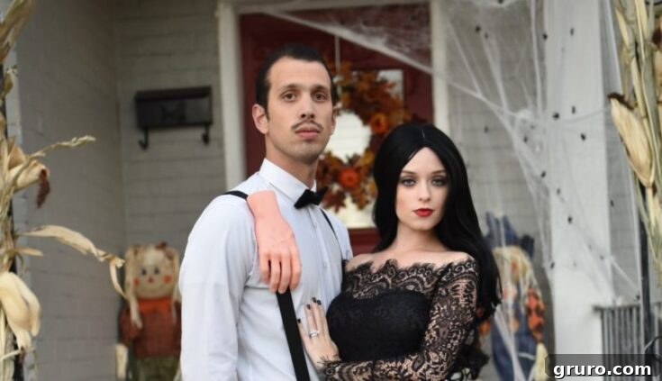 A couple dressed as Gomez and Morticia Addams, capturing the dark elegance and passionate romance of the Addams Family.