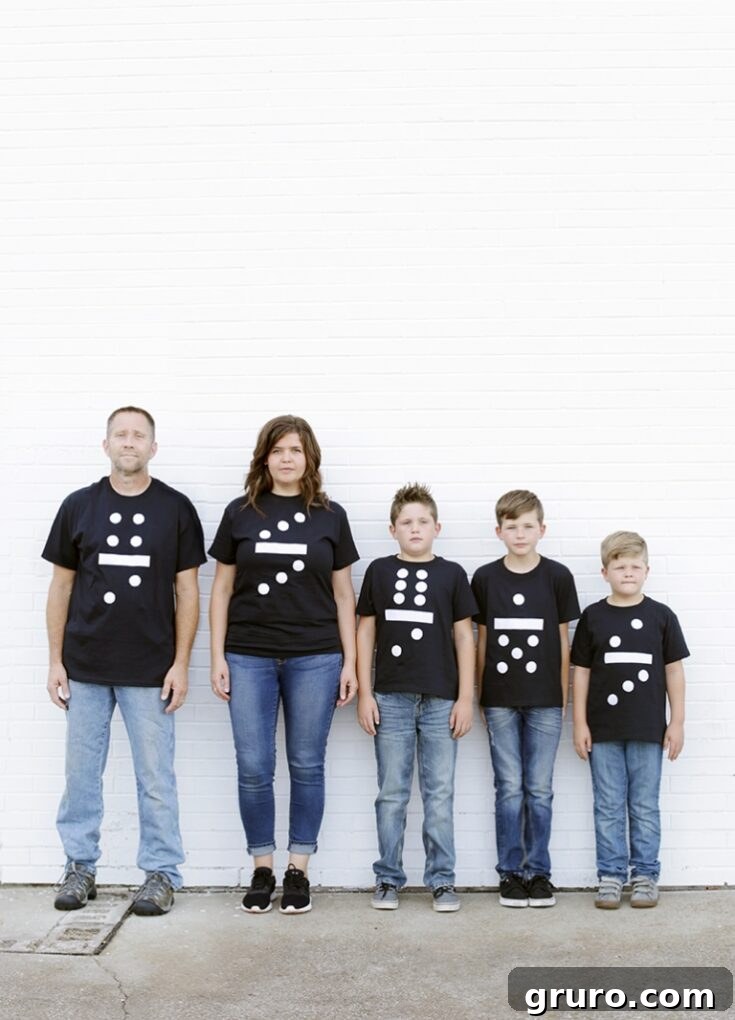 A couple dressed as two domino pieces, featuring black t-shirts with white iron-on vinyl dots.