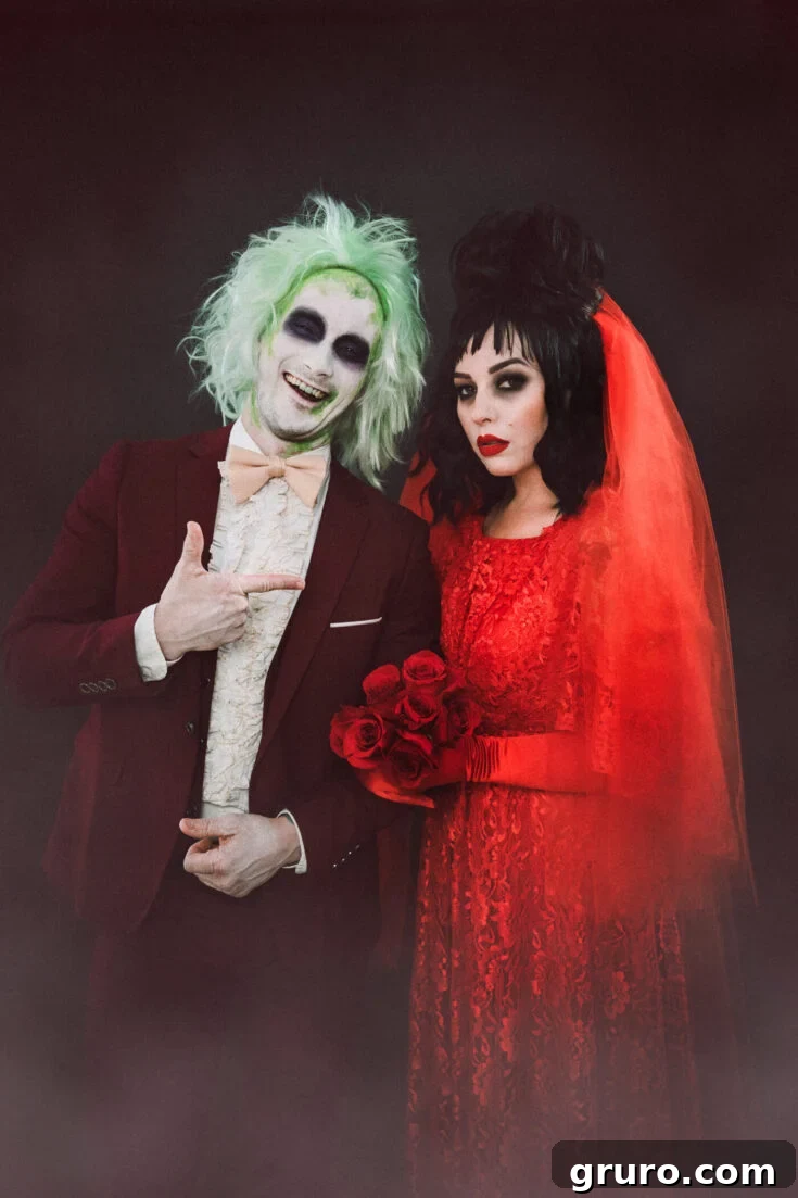 A couple dressed as Beetlejuice and Lydia Deetz in their wedding day attire, embodying the eerie and romantic Tim Burton aesthetic.