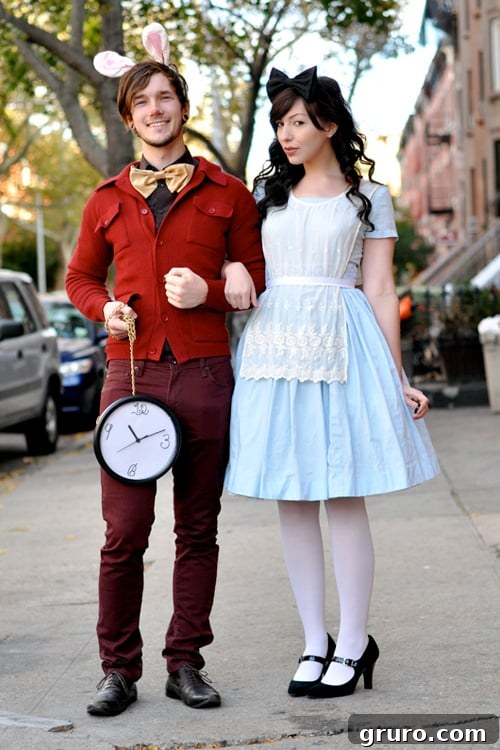 A couple dressed as a modern Alice and a punk-rock White Rabbit from Alice in Wonderland.