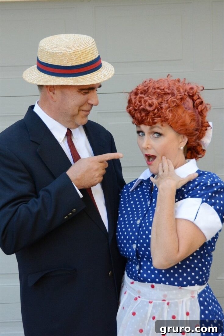 A couple dressed as Lucy and Ricky Ricardo from the classic TV show 'I Love Lucy', showing their timeless humor and style.