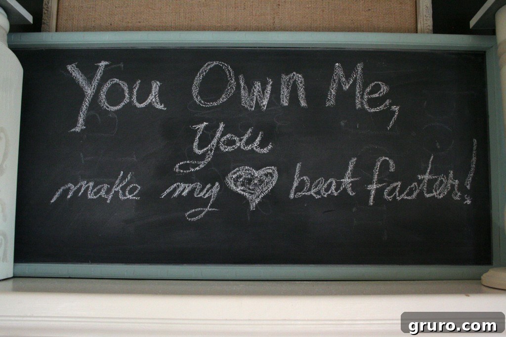 Chalkboard art on a mantel displaying song lyrics for Valentine's Day