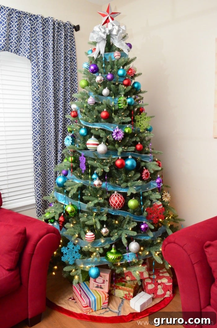 Our new Martha Stewart Living 7.5 ft. Feel-Real Artificial California Cedar Christmas Tree adorned with Jingle Brights ornaments, a vibrant holiday transformation.