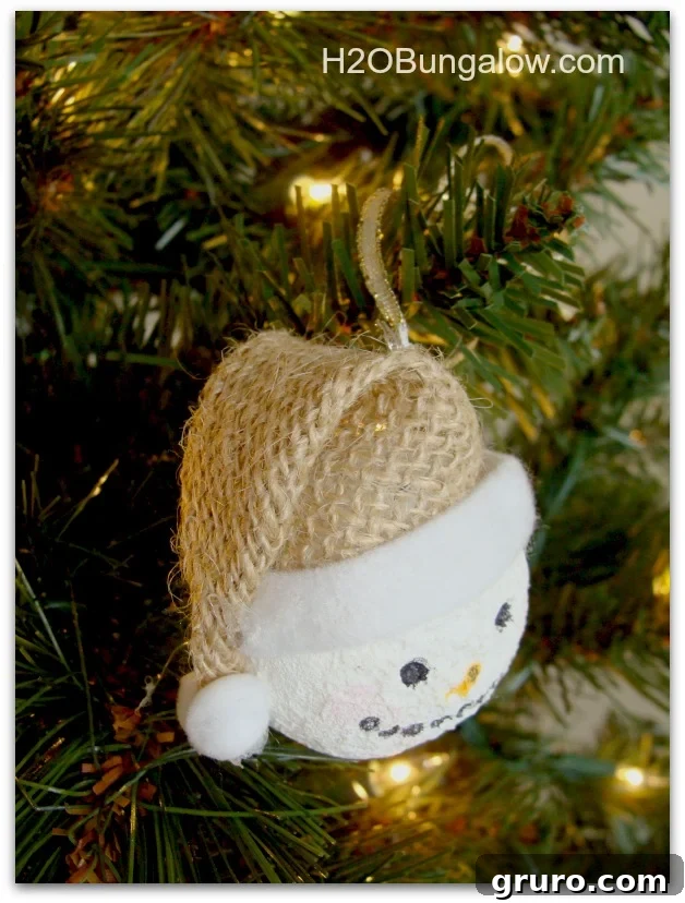 Another angle of a handmade snowman ornament, highlighting its unique hat design and charming details.
