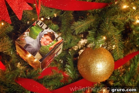 The Instagram Time Capsule Ornament hanging on a festive Christmas tree, sparkling with holiday cheer.