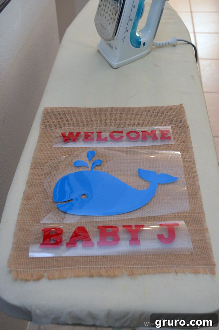 Positioning Iron-On Vinyl on Burlap for Baby Shower Flag