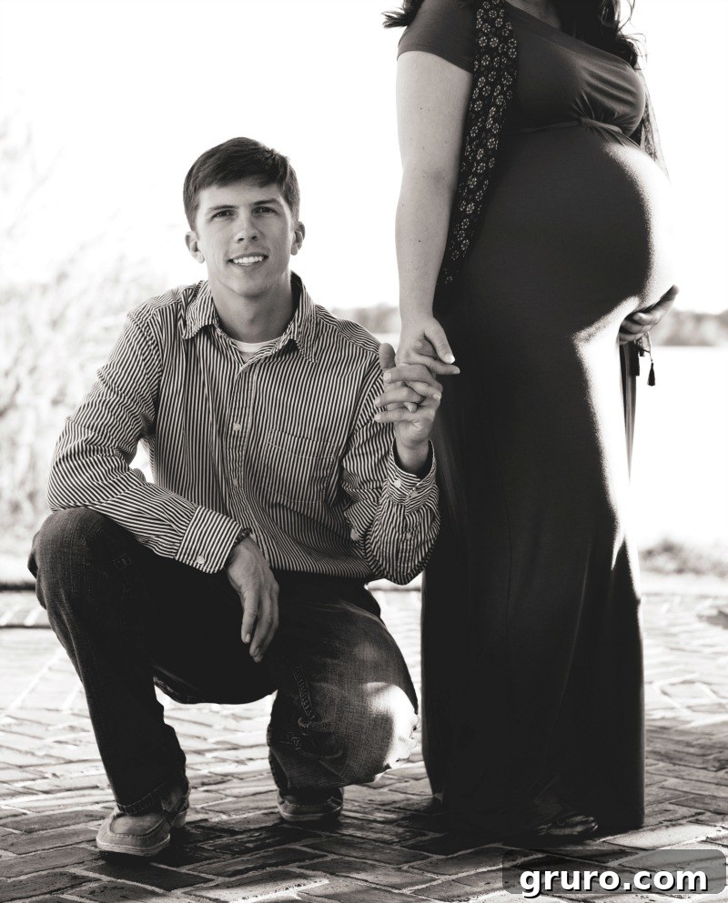 Proud expectant father cradling the baby bump, heartfelt male maternity photo