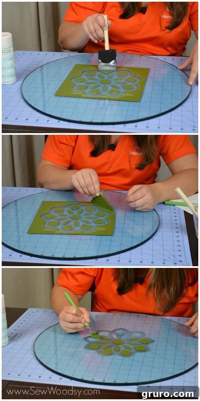 Close-up of glass etching cream being applied over a floral vinyl stencil