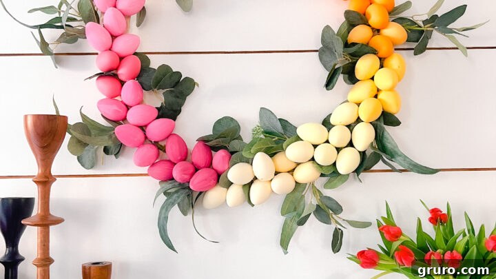 A vibrant, colorful ombre Easter egg wreath, perfect for welcoming spring guests.