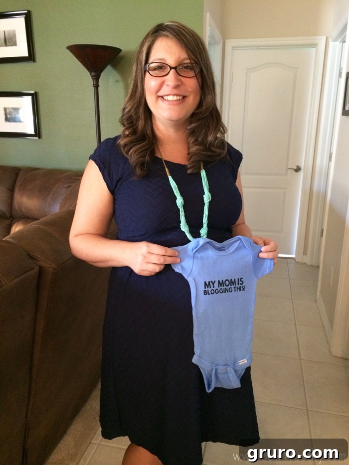 A baby onesie with the funny phrase 'My Mom Is Blogging This'