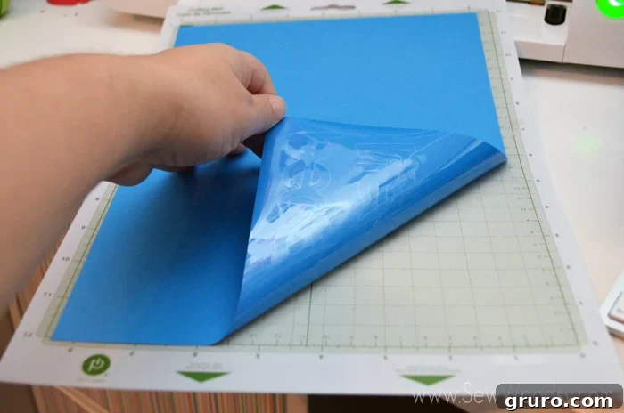 Pre-cut Iron-On Vinyl designs laid out for guests at a baby shower