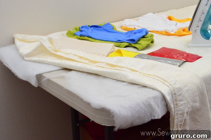 Organized Baby Shower Onesie Station with irons, designs, and onesies on a table