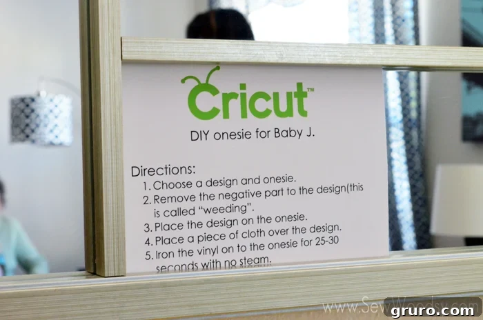 Clear, visual instructions for applying Iron-On Vinyl displayed at a onesie station