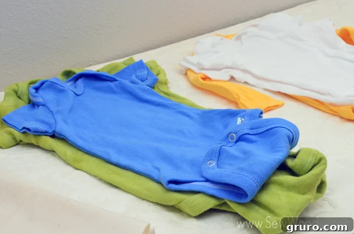 A neatly organized display of different colored onesies for guests to choose from
