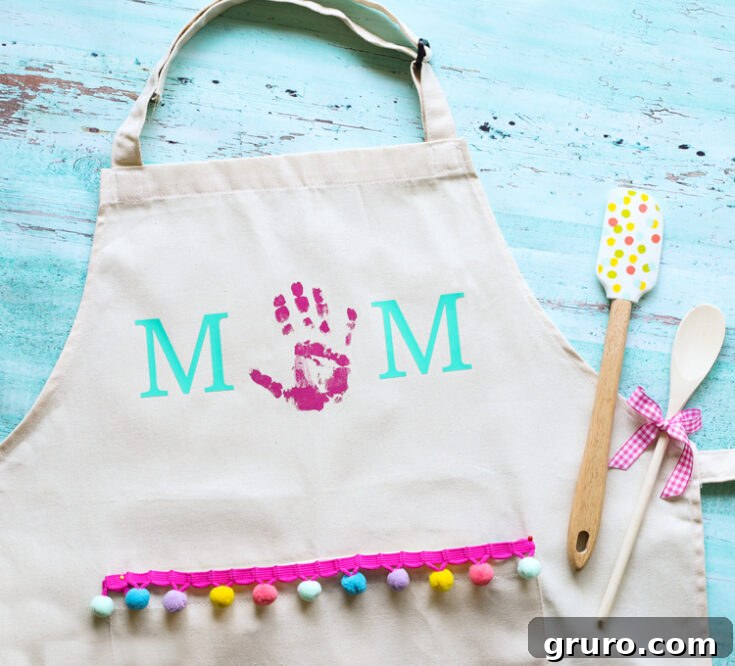 A personalized apron featuring colorful handprints from children, a practical and sentimental Mother's Day gift for the cooking enthusiast.