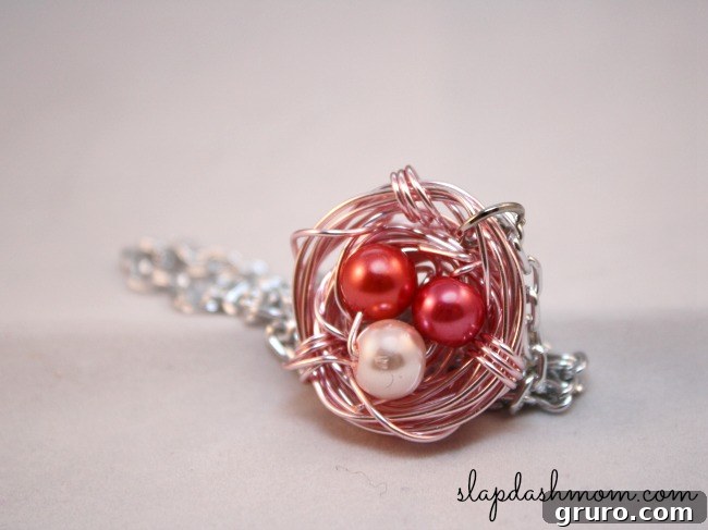 An intricate DIY bird nest necklace, featuring small pearl 'eggs' nestled within wire, symbolizing family and motherhood, a beautiful Mother's Day gift.