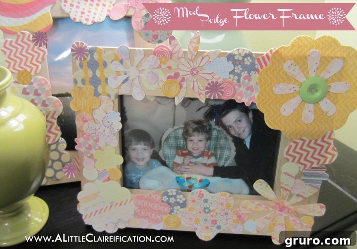 A vibrant photo frame decorated with colorful paper flowers using Mod Podge, a cheerful and easy Mother's Day craft idea.