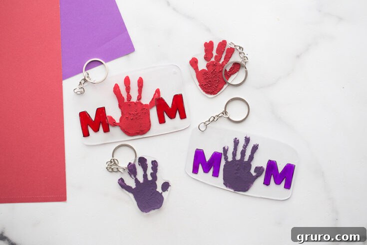 A collection of adorable Shrinky Dink keychains, featuring handprints and personalized messages, perfect as a sentimental Mother's Day gift.