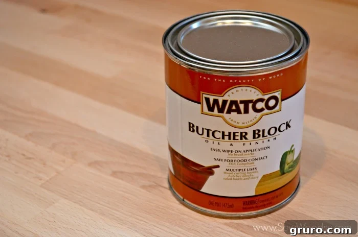 A can of Watco Butcher Block Oil and Finish placed on a light wood surface, emphasizing the product used for sealing the countertops.