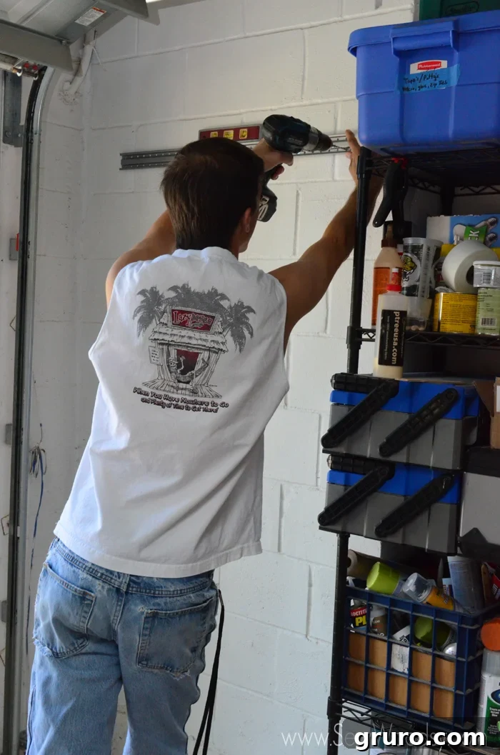 Clean and organized garage corner after installing Rubbermaid FastTrack hanging storage