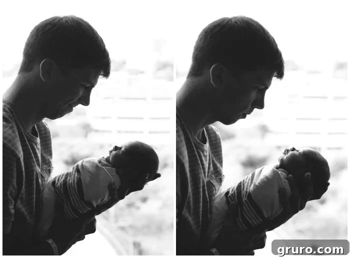 A loving father holding his newborn son's tiny hand, showcasing a precious bond during Fresh 48 newborn photography.