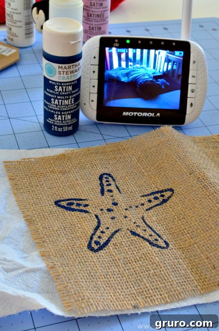 Rustic Sea Star Craft 8 A beautiful, freshly stenciled burlap starfish design drying on a craft surface, awaiting the next steps in creating DIY Nautical Burlap Starfish Art.