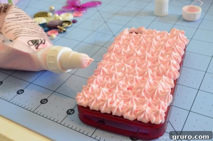 A cell phone case completely covered with a thick, textured layer of Strawberry Pink Mod Podge Collage Clay. The clay is evenly applied, creating a soft, whipped-cream-like appearance, serving as the perfect foundation for intricate Decoden decorations.