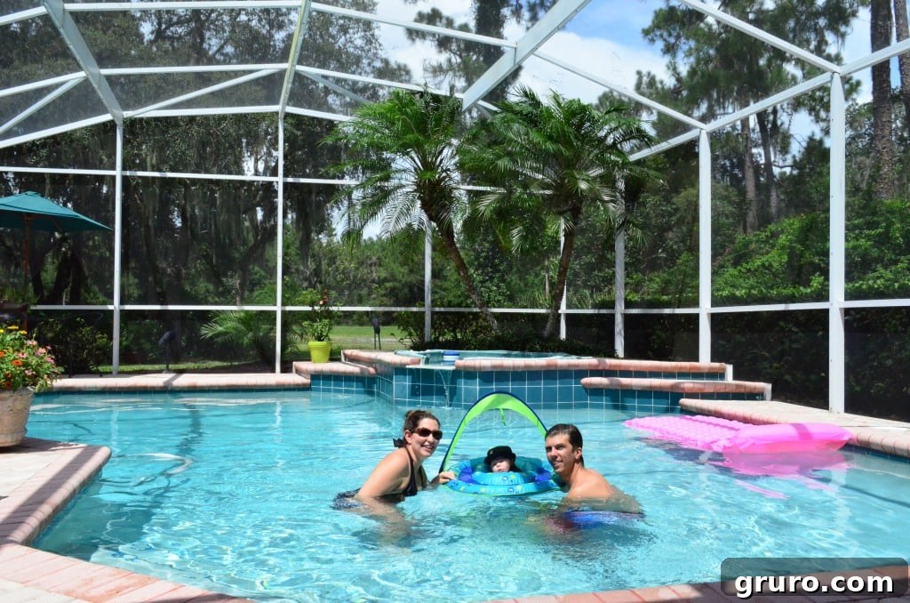 Family photo in the pool with baby Ryder after his first swim experience together
