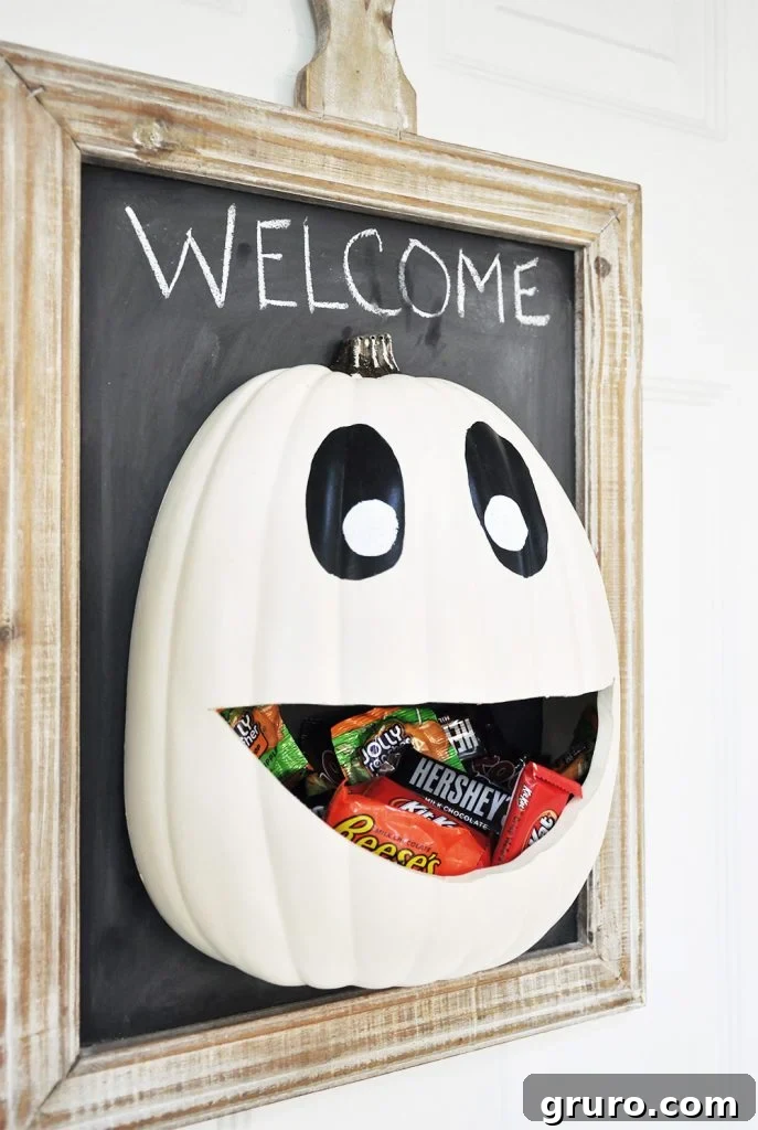 A Halloween candy door hanger shaped like a witch's hat with various candies attached.