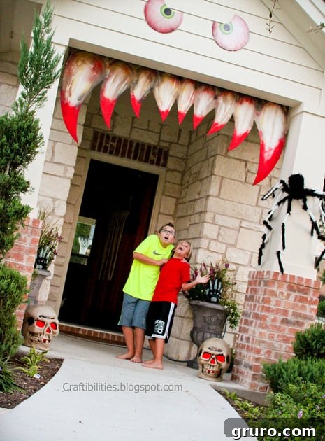 A house decorated as a monster face for Halloween, with eyes and fangs around the entrance.