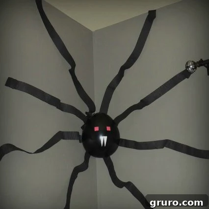 A large, realistic-looking spider decoration with hairy legs, creating a frightful Halloween display.