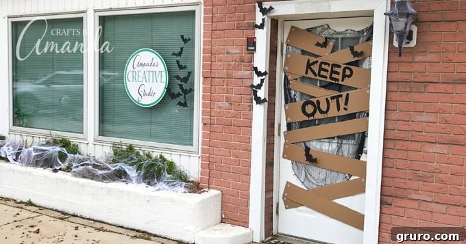 A Halloween door decoration with a 'Keep Out!' sign and spooky accents, creating a haunted entrance.