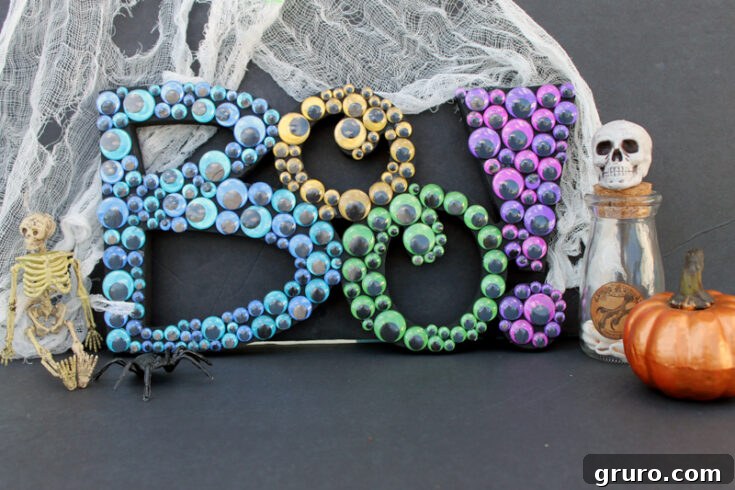 A 'Boo' sign for Halloween, decorated with lights and ribbons, creating a fun and colorful outdoor decoration.
