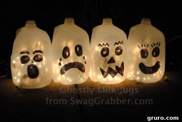 Several ghostly milk jugs with drawn faces, illuminated from within, creating an easy and inexpensive Halloween decoration.