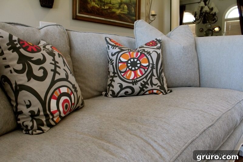 Finished Sofa Makeover The newly reupholstered and painted sofa, looking elegant and refreshed.