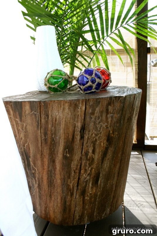 A rustic log table made from a tree stump, serving as a unique and natural addition to outdoor decor.