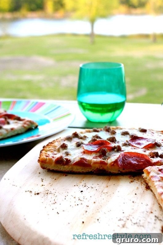 A delicious grilled pizza, even if frozen, served outdoors for an easy and enjoyable meal on the porch or patio.