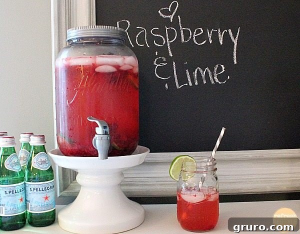 A large mason jar filled with refreshing raspberry infused water, perfect for sipping on the porch or patio.