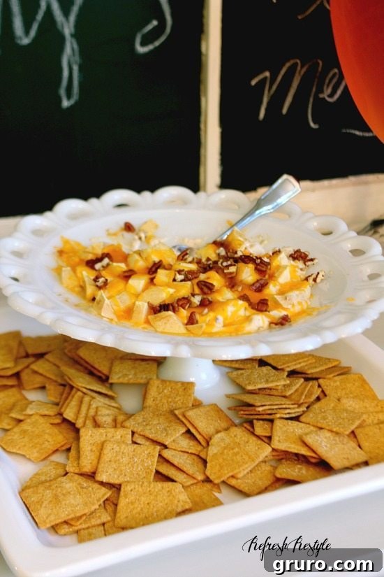 Effortless Holiday Hosting 6 Serving of Hot Apple Pie Dip with Wheat Thins, showing off the delicious texture.