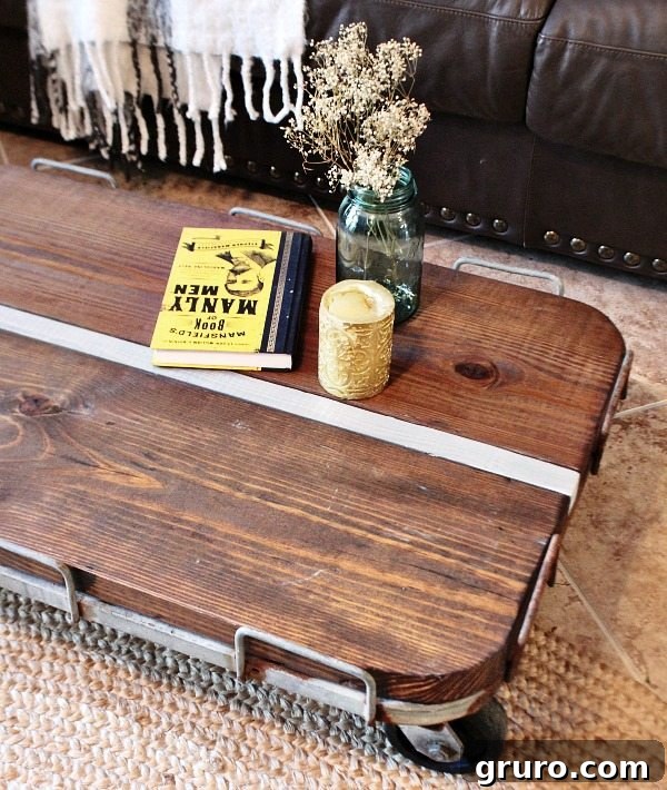 Build Your Industrial Cart Coffee Table 11 Rustic farmhouse cart transformed into a DIY coffee table, showcasing the stained wood and metal frame.