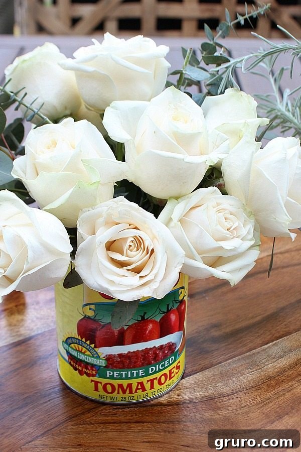 Untamed Farmhouse Florals 7 Roses elegantly arranged in a recycled tomato can, showcasing the charm of a farmhouse flower arrangement