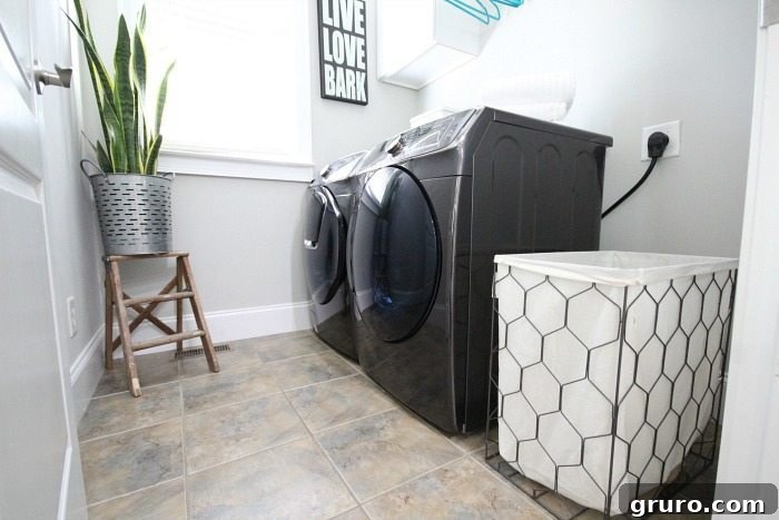 A complete view of the small yet stunning laundry room after makeover, featuring Samsung's black stainless steel appliances